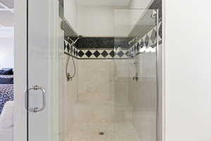 Ensuite bathroom featuring a stall shower