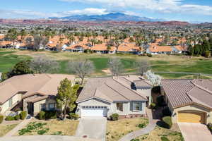 Aerial perspective of suburban area featuring a golf course and mountains