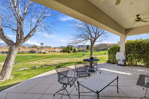 View of patio / terrace featuring a residential view, ceiling fan, area for grilling, and view of golf course