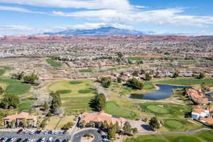 Aerial view of residential area featuring a local golf course and a water and mountain view