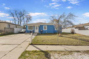Bungalow-style home featuring a fenced front yard and driveway