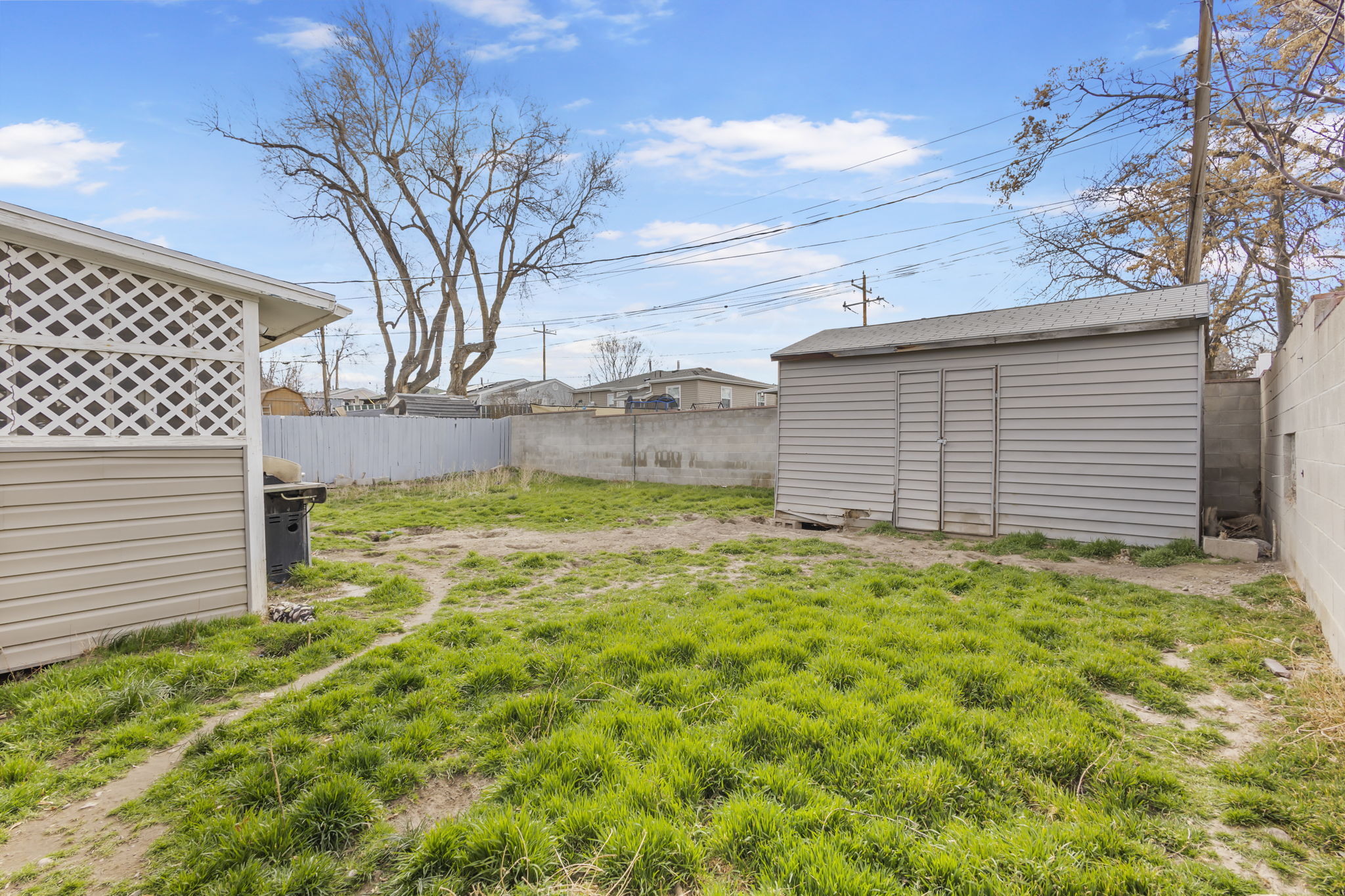 Fenced backyard with a shed