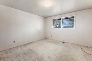 Unfurnished room featuring carpet and baseboards