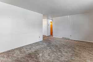 Empty room with carpet floors and baseboards