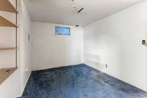 Carpeted spare room with a textured ceiling