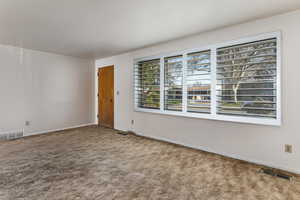Unfurnished room with carpet flooring and baseboards