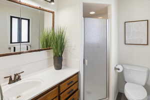 Full bathroom with a stall shower and vanity