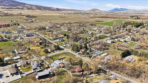 Aerial overview of property's location with nearby suburban area and mountains
