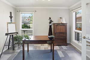 Office featuring light flooring, crown molding, and plenty of natural light