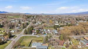Aerial perspective of suburban area featuring a mountainous background