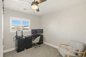 Office with light colored carpet and a ceiling fan
