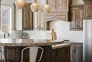 Kitchen with dark wood finish cabinets and light stone countertops