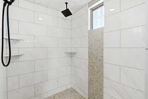 Full bath with a tile shower
