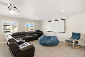 Home theater featuring light colored carpet and recessed lighting