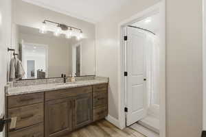 Full bathroom featuring vanity, a shower with curtain, light wood finished floors, and recessed lighting