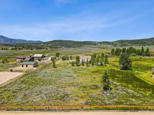 View of mountain backdrop with rural landscape