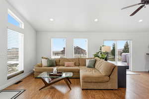 Living area featuring healthy amount of natural light, a ceiling fan, wood finished floors, and recessed lighting