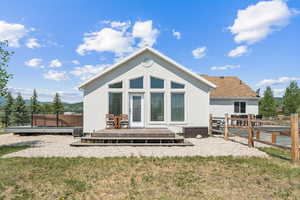 Back of property with stucco siding and a deck