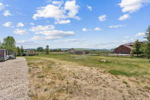 View of yard featuring a view of countryside and an outbuilding