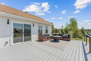 Wooden terrace featuring an outdoor living space with a fire pit