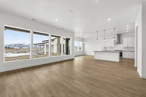 Great room and kitchen featuring wall of windows facing east to Wasatch Mountain range
