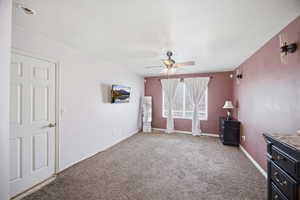 Unfurnished bedroom with carpet flooring and ceiling fan