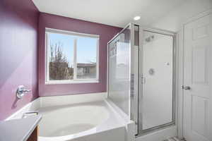 Bathroom with a garden tub and a stall shower