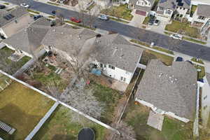 Aerial view of property and surrounding area featuring nearby suburban area