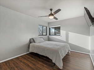 Bedroom #1 featuring dark wood-style flooring and a ceiling fan