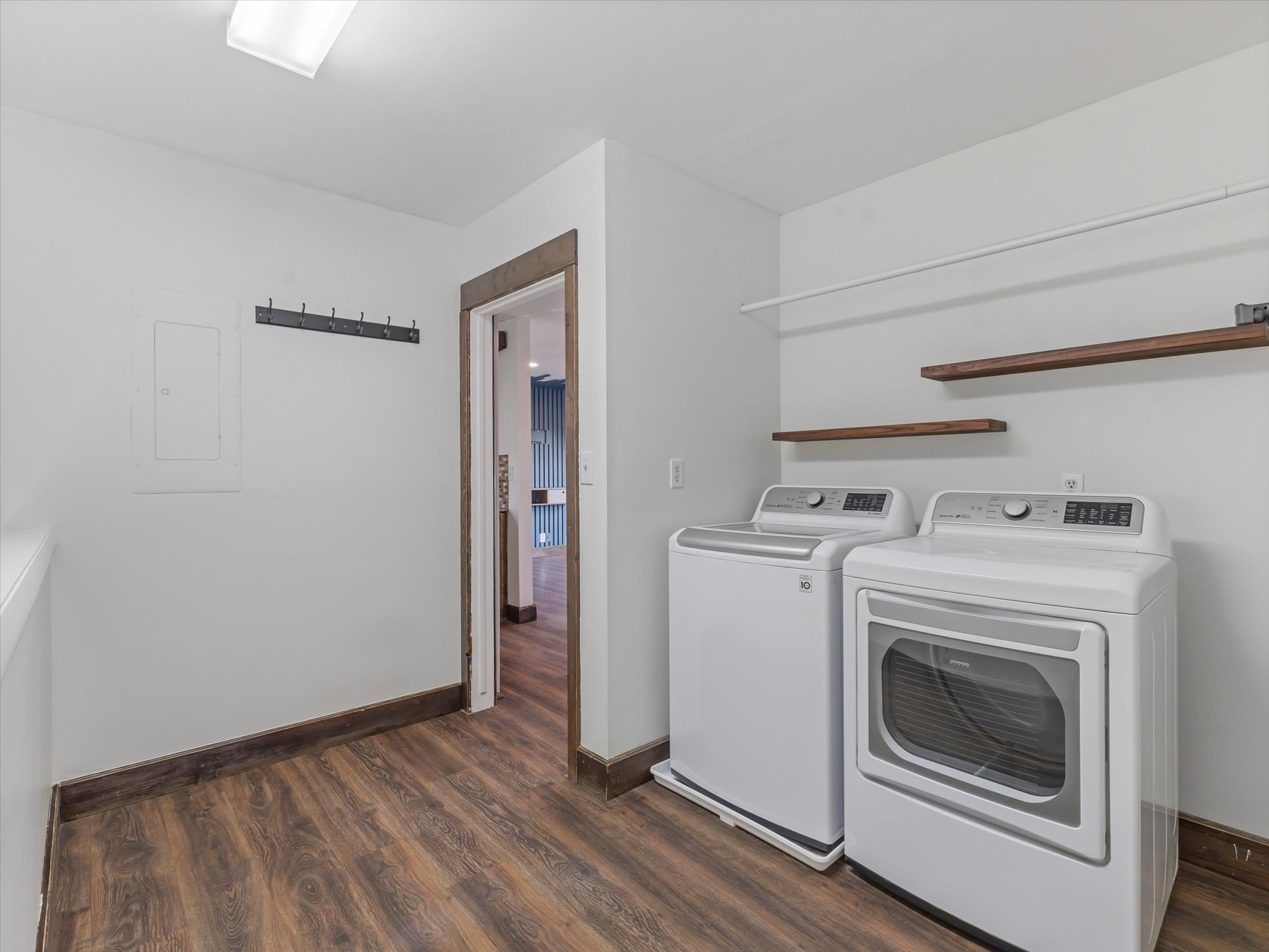 Laundry area with dark wood-style flooring