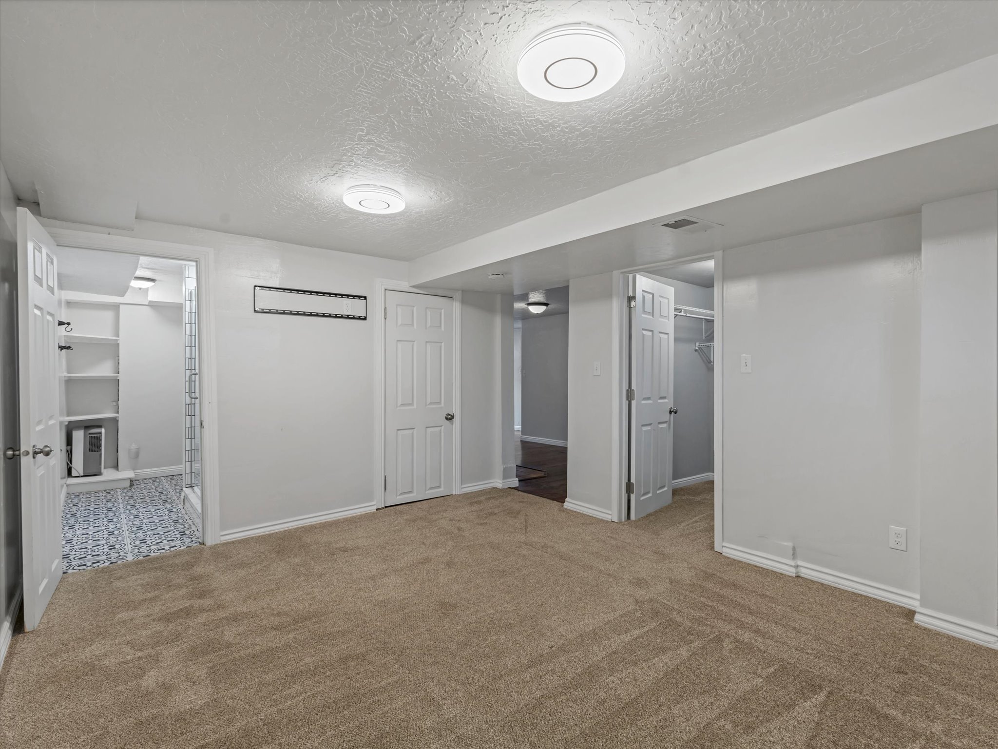 Bedroom #4 featuring a textured ceiling and carpet floors