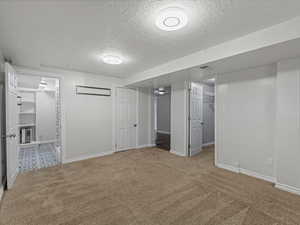 Bedroom #4 featuring a textured ceiling and carpet floors
