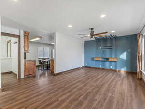 Unfurnished living room featuring recessed lighting, dark wood-style flooring, and a ceiling fan
