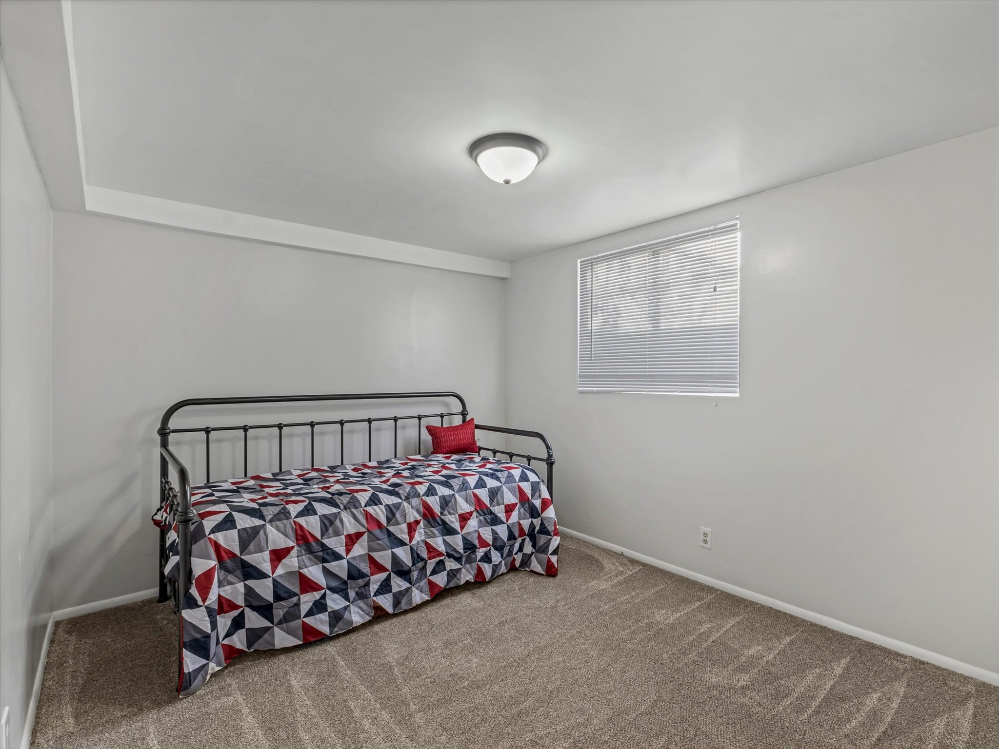 Bedroom #3 with light carpet and baseboards