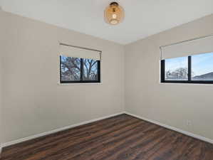 Bedroom #2 featuring dark wood finished floors and baseboards