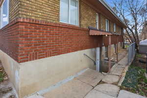 View of property exterior with brick siding