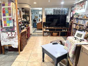 Living area with light tile patterned floors and recessed lighting