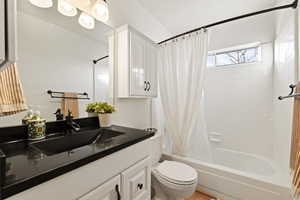 Full bathroom with vanity and shower / bath combination with curtain
