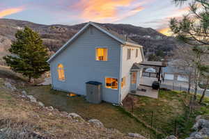 View of side of home featuring a patio and a mountain view