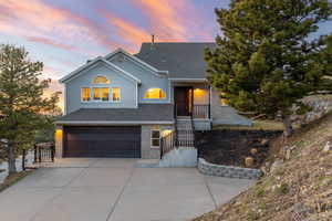 View of front of house featuring brick siding, an attached garage, and concrete driveway