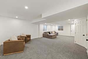 Carpeted living area featuring recessed lighting