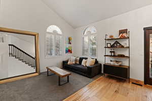 Living room featuring lofted ceiling and light wood-type flooring