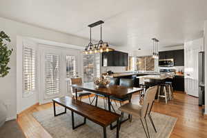Dining area with light wood-type flooring and baseboards