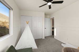 Game room with carpet and ceiling fan