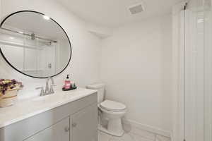 Bathroom with vanity and light marble finish flooring