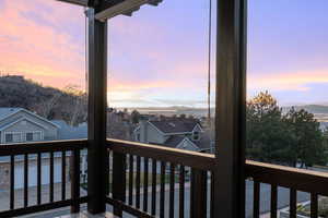 Deck at dusk with a balcony and a mountain view