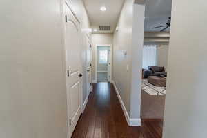 Hallway featuring dark wood-style floors and recessed lighting