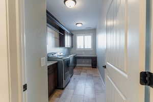 Laundry room with cabinet space and washer and dryer