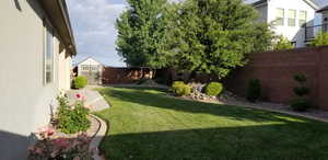 Fenced backyard with a storage unit