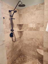 Full bath featuring tiled shower